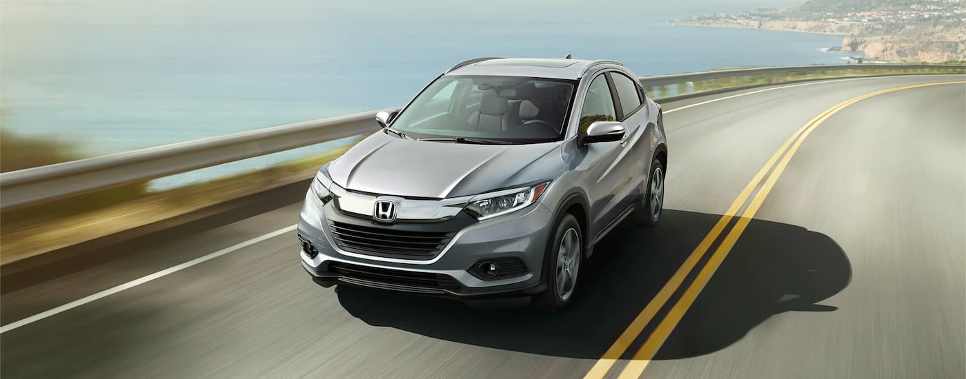 A silver 2022 Honda HR-V is shown driving on an open road.