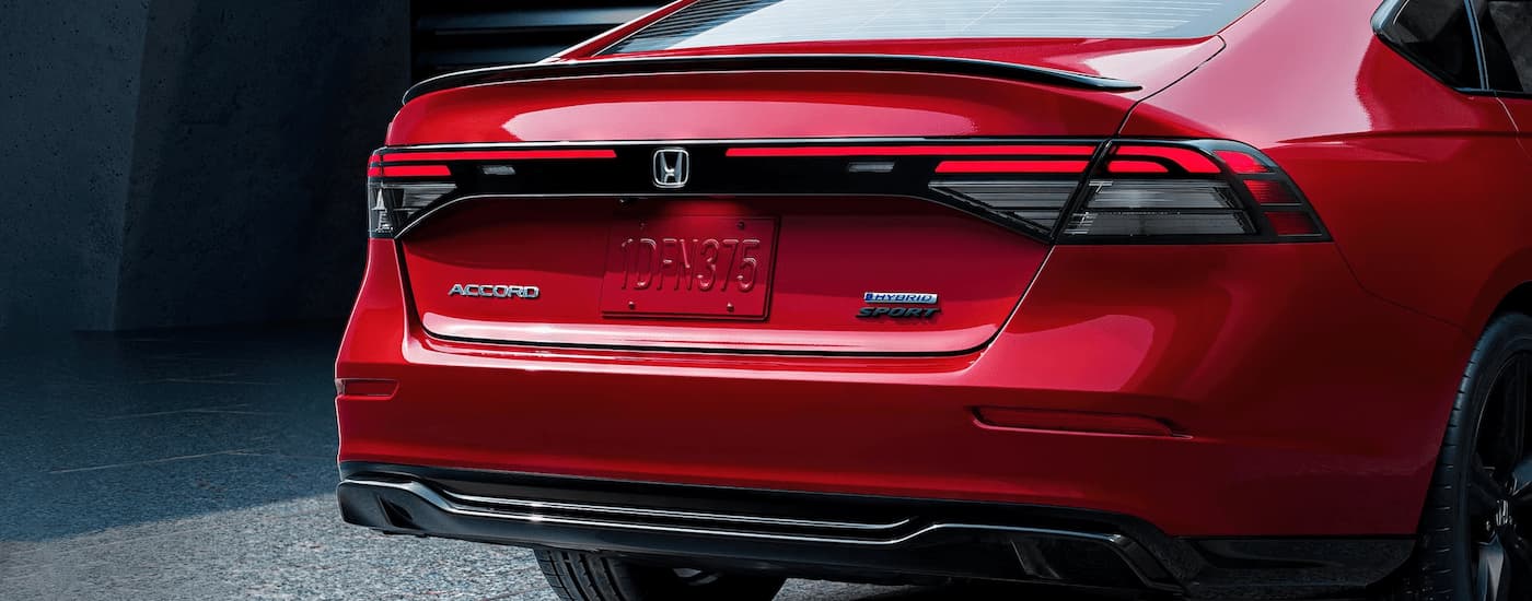 A close up of the rear trunk of a red 2023 Honda Accord Sport Hybrid is shown.