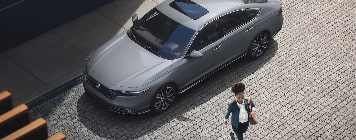 A person is shown walking away from a 2023 Honda Accord Touring.