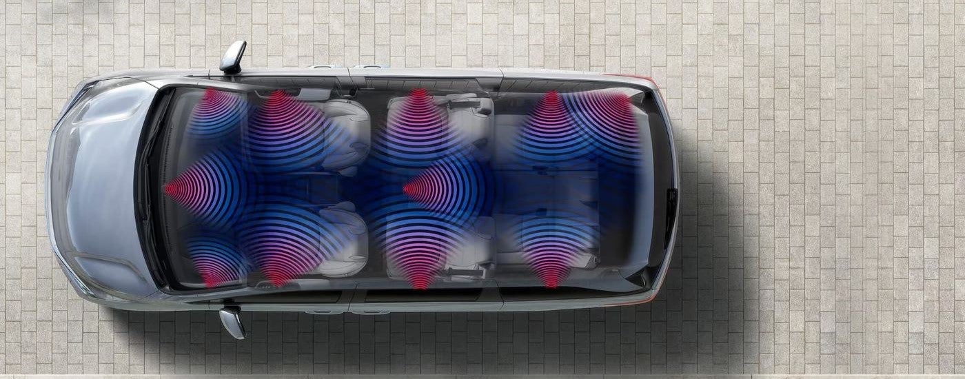 A silver 2024 Honda Odyssey Elite is shown from an aerial view with simulated speaker lines.