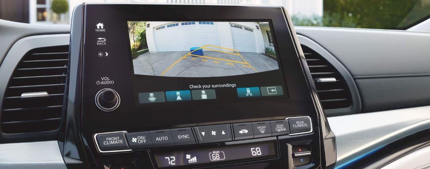 A close up shows the infotainment screen back up camera view in a 2024 Honda Odyssey Elite.