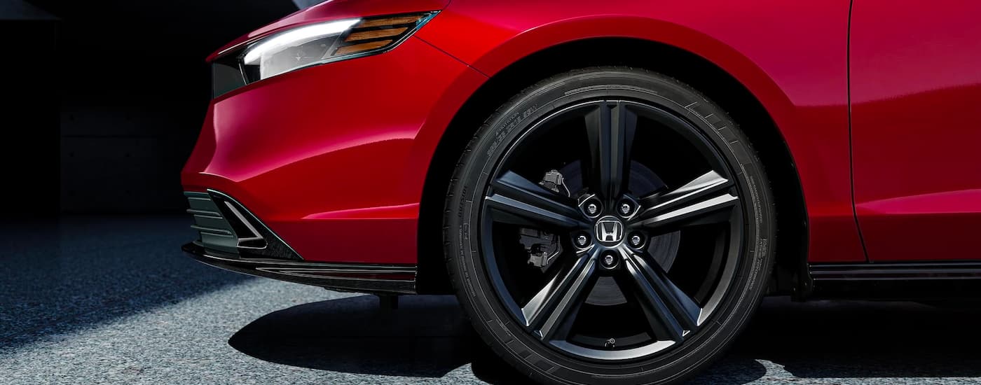 A close up of the tire on a red 2023 Honda Accord Sport Hybrid is shown.