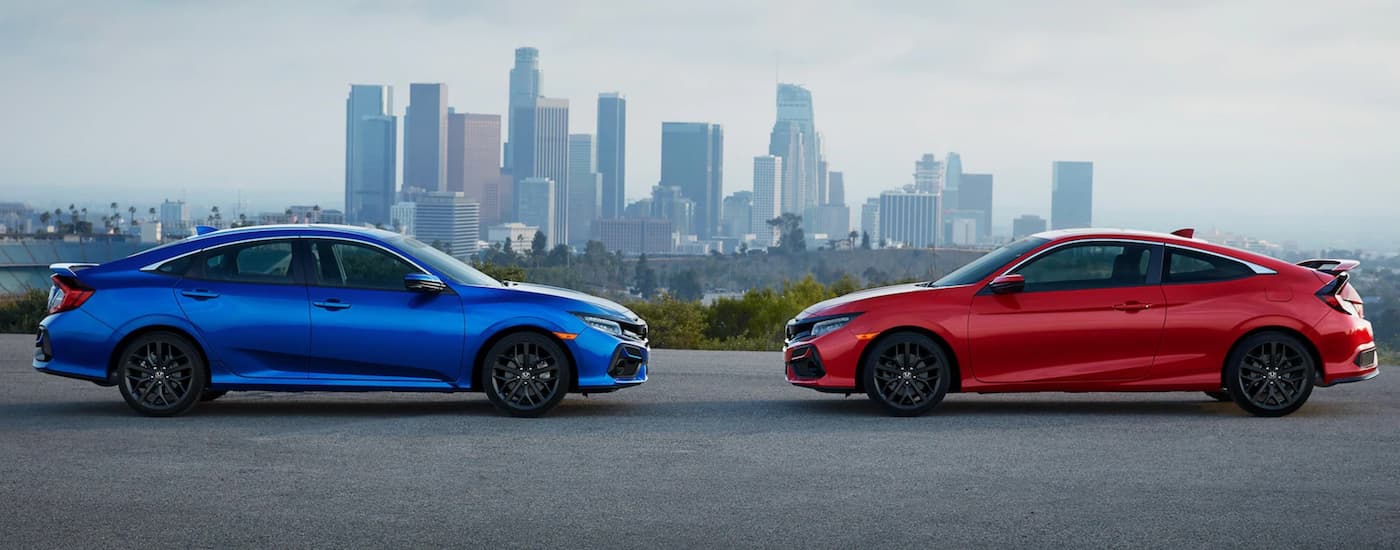 A blue and a red 2021 Honda Civic Si are parked facing each other.