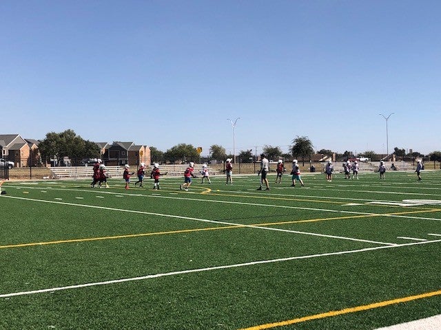 Local Texas Lacrosse Team Practicing in a Green Field